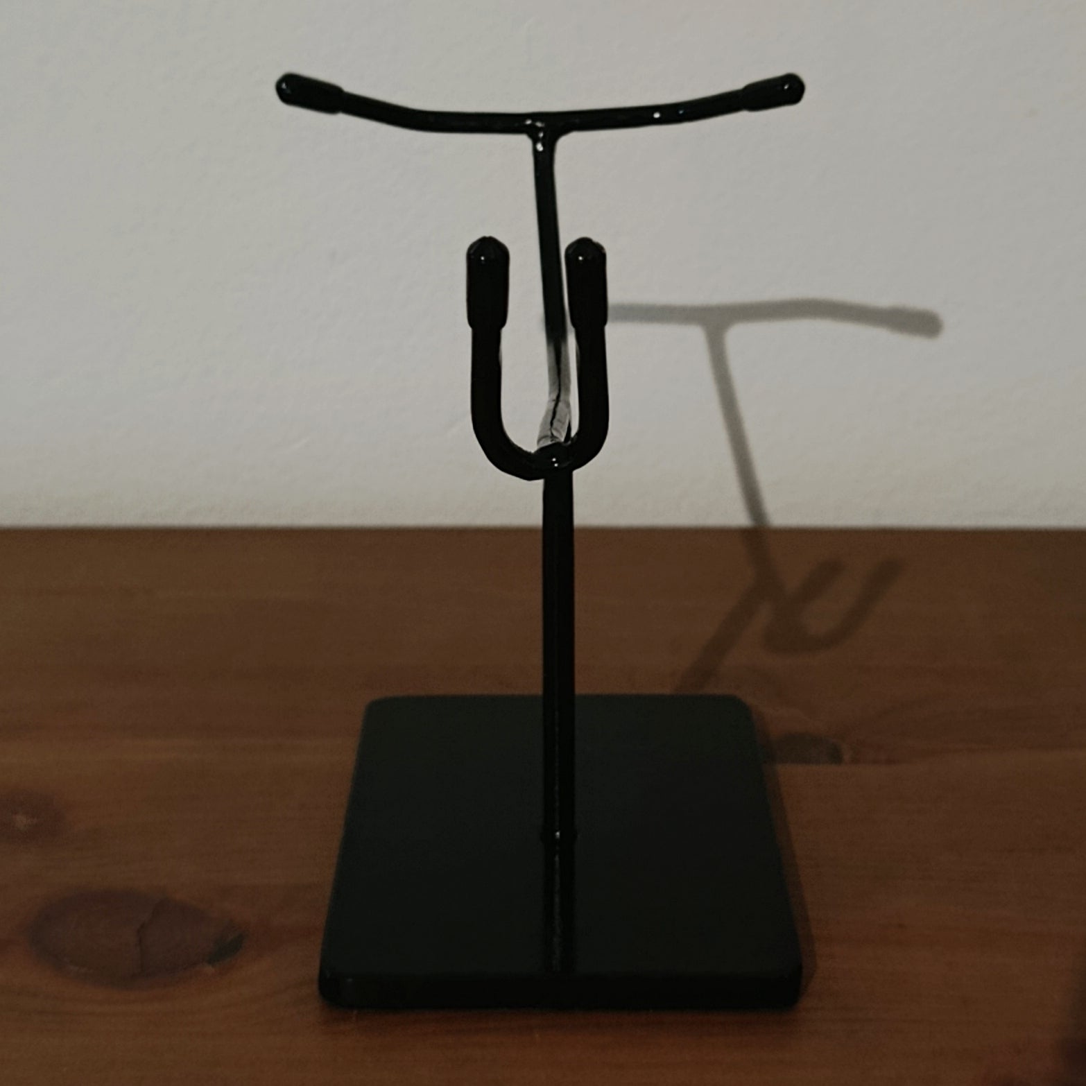 Black gloss metal skull stand designed for mandible-free skulls, offering a clean, stable and museum-grade solution for anatomical and archaeological displays.