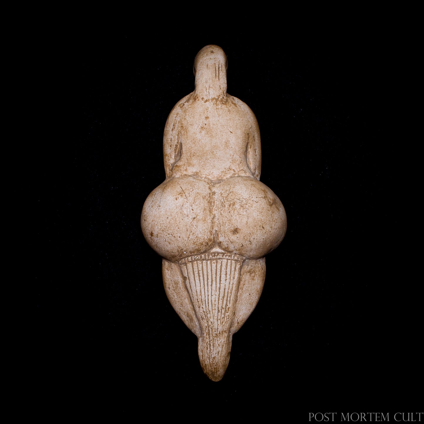 Three-quarter view highlighting the sculptural form and exaggerated anatomical proportions characteristic of Upper Paleolithic Venus figurines.