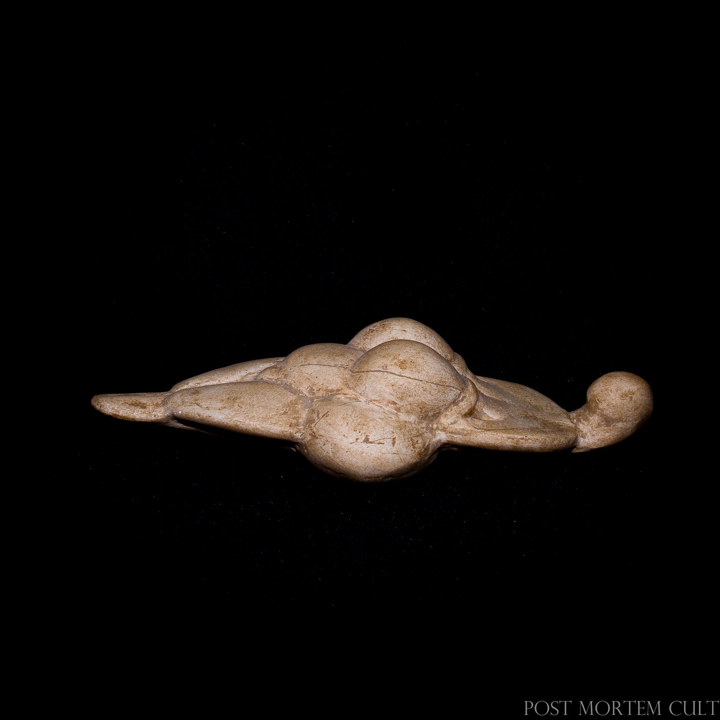 Detailed frontal perspective of the prehistoric Venus sculpture replica, emphasizing its rounded forms and symbolic fertility attributes.