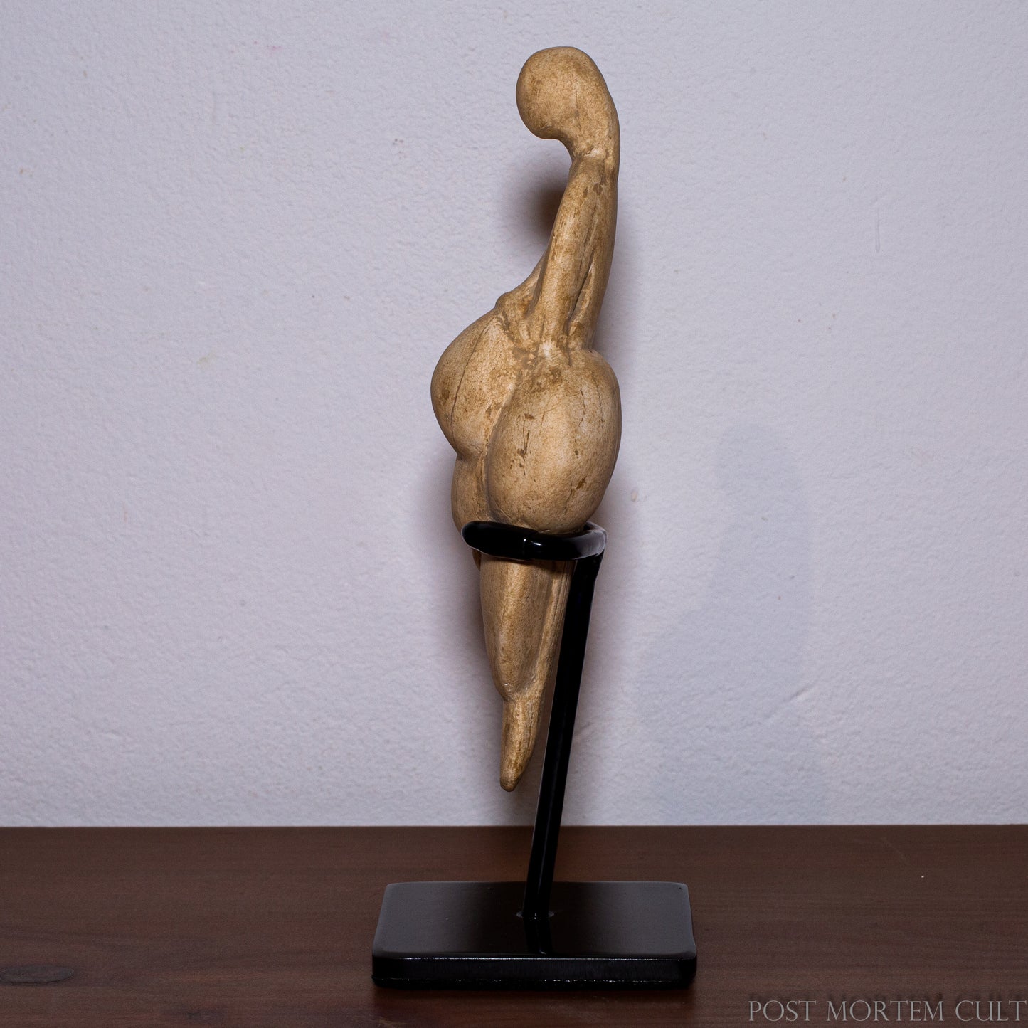 Studio display of the Venus of Lespugue Paleolithic figurine replica mounted on a minimalist stand for collectors and curiosity cabinets.