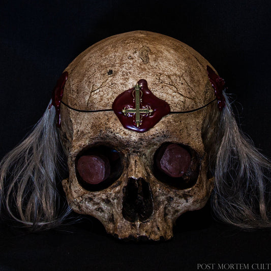 Close-Up of the Witch Skull Replica
A detailed close-up of the 16th-century witch skull replica, showcasing its realistic texture and hand-painted finish. The wax seal and oxidized nails add a historically accurate touch, emphasizing the craftsmanship and antique feel.