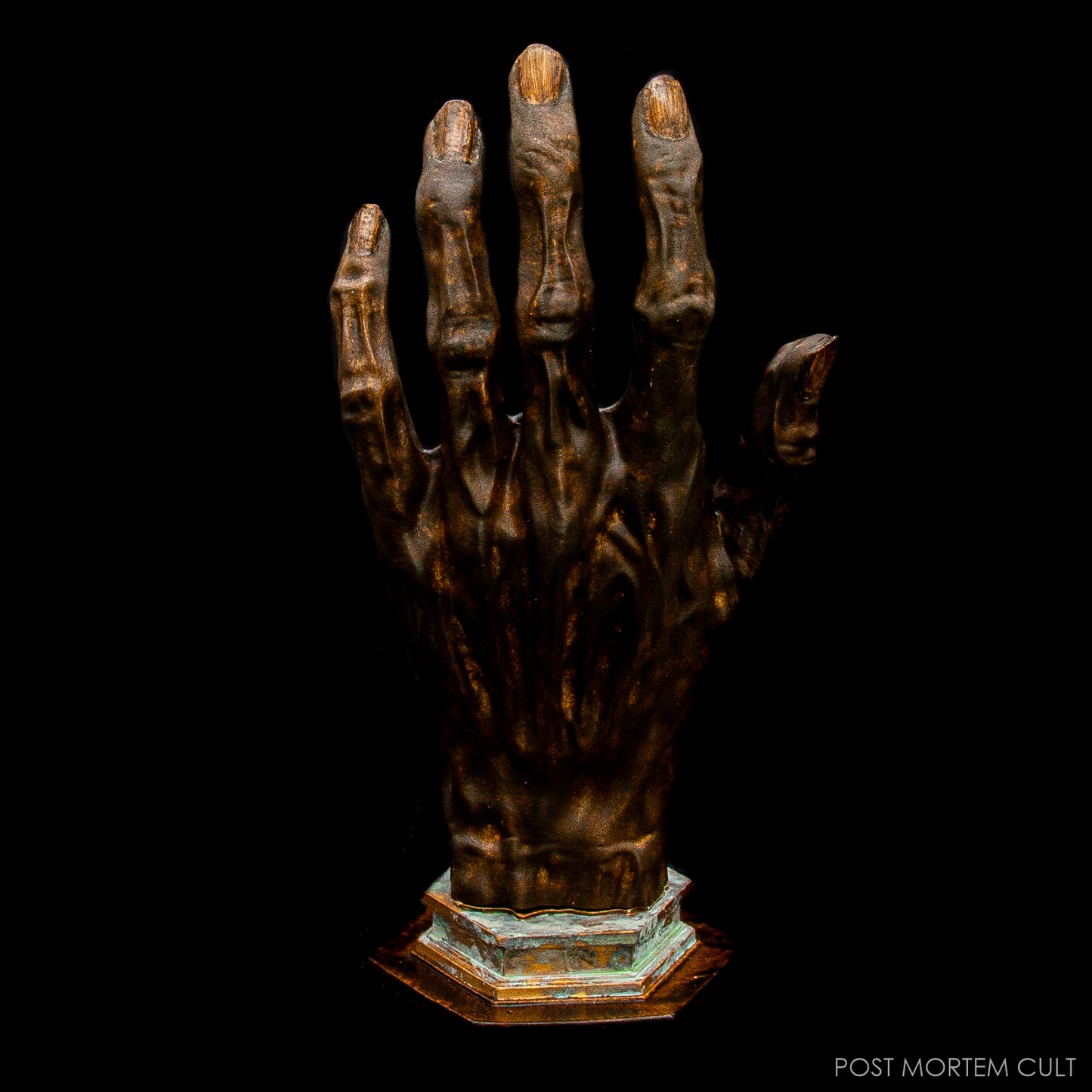 Close-up of Hand of Glory sculpture showing aged patina and lifelike detail.