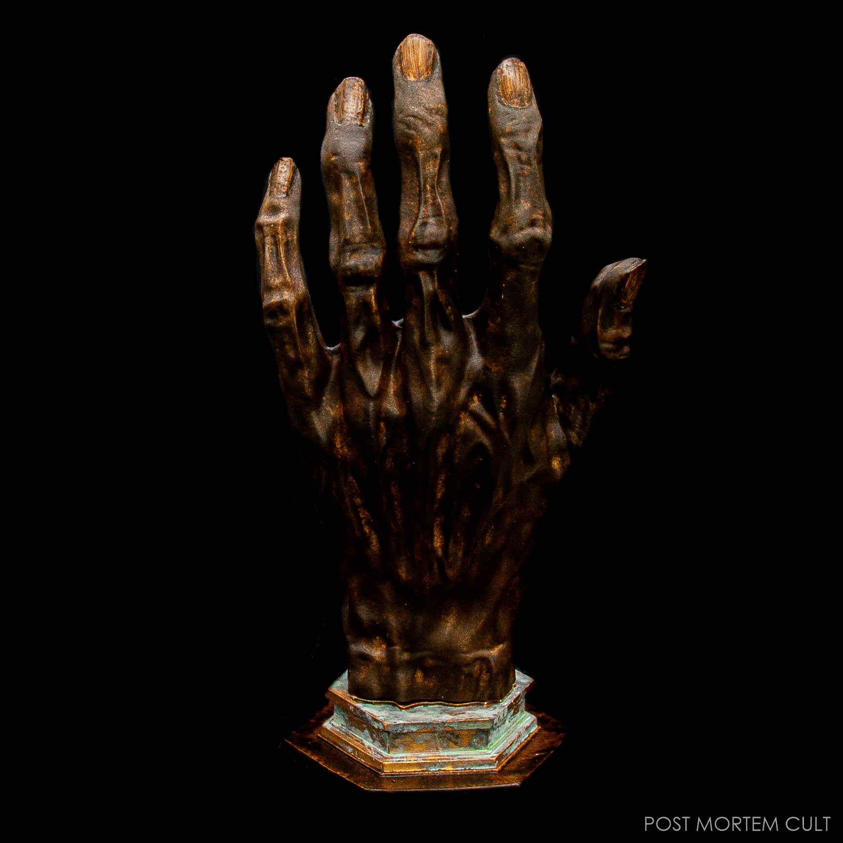 Close-up of Hand of Glory sculpture showing aged patina and lifelike detail.