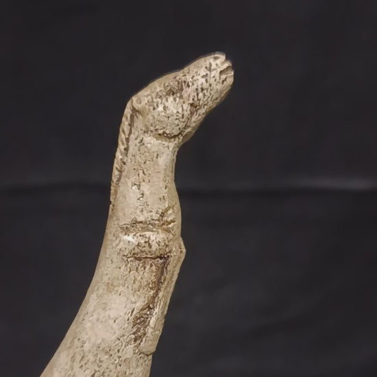 Museum-inspired Paleolithic atlatl replica featuring worn surfaces, porous textures and refined sculptural movement characteristic of Ice Age portable art.